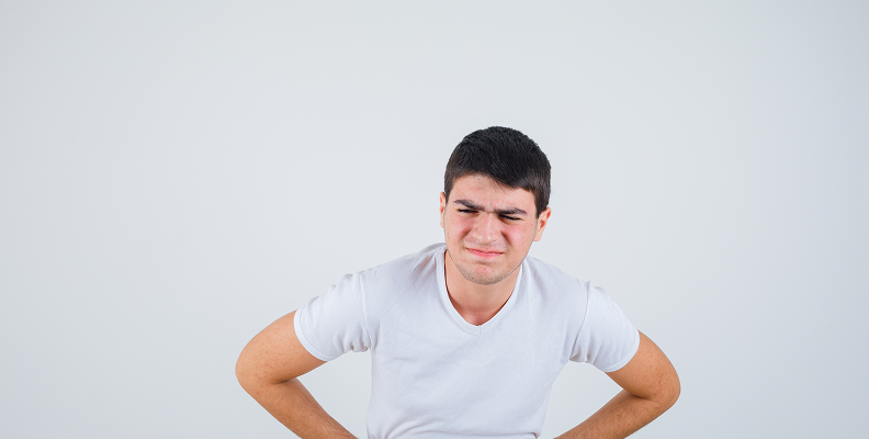 Piles young male suffering from stomachache t shirt looking painful front view 1